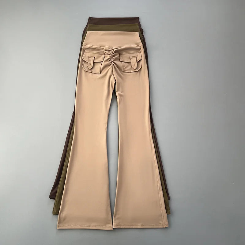 Beige bell-bottom pants with brown accents on a gray background