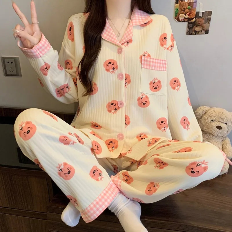 Person wearing a pajama set with cartoon designs sitting on a couch.