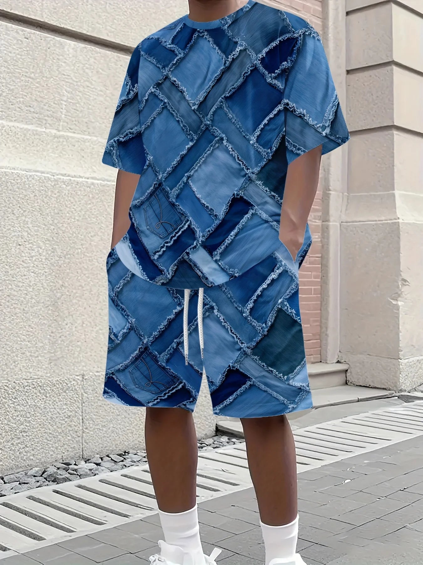 Person wearing a blue denim outfit with a textured pattern in an urban setting.