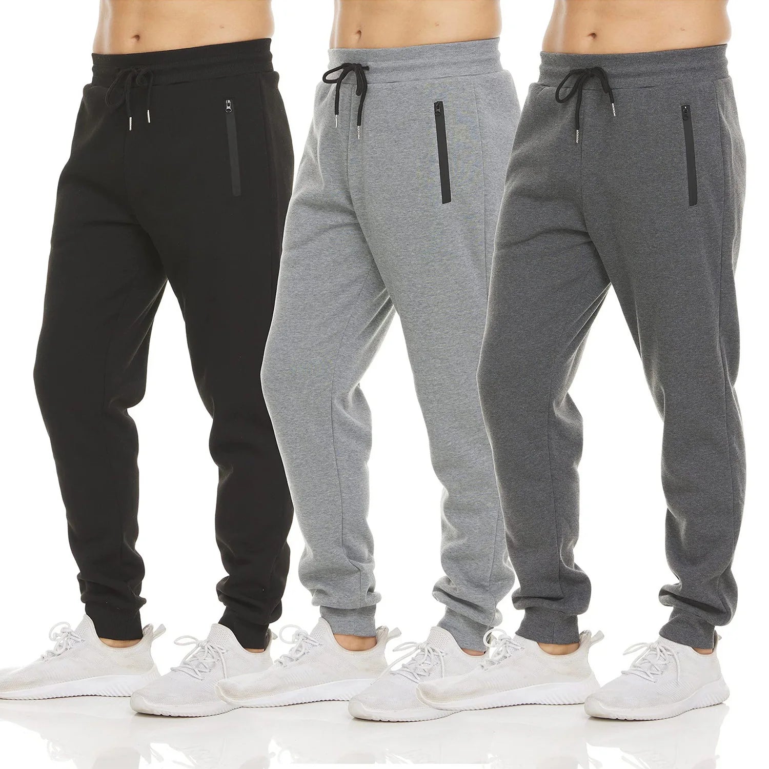 Three pairs of jogger pants in black, gray, and another gray shade on a white background.