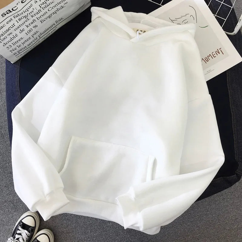 White hoodie with 'C'EST LA VIE PARIS' text on a surface with newspapers.