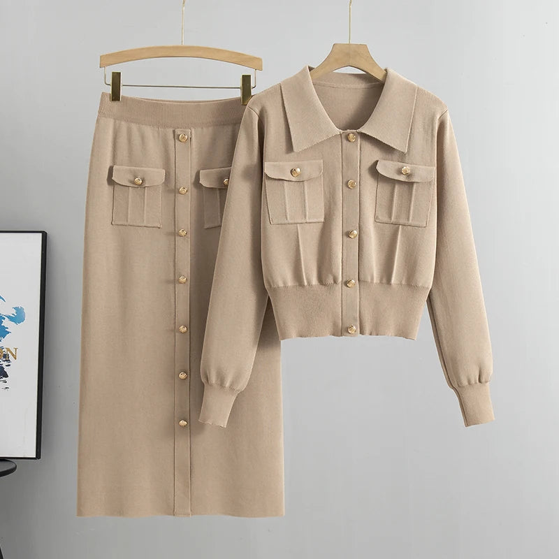 Beige jacket and skirt set on hangers against a gray background