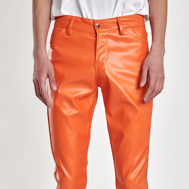Person wearing bright orange pants on a plain background