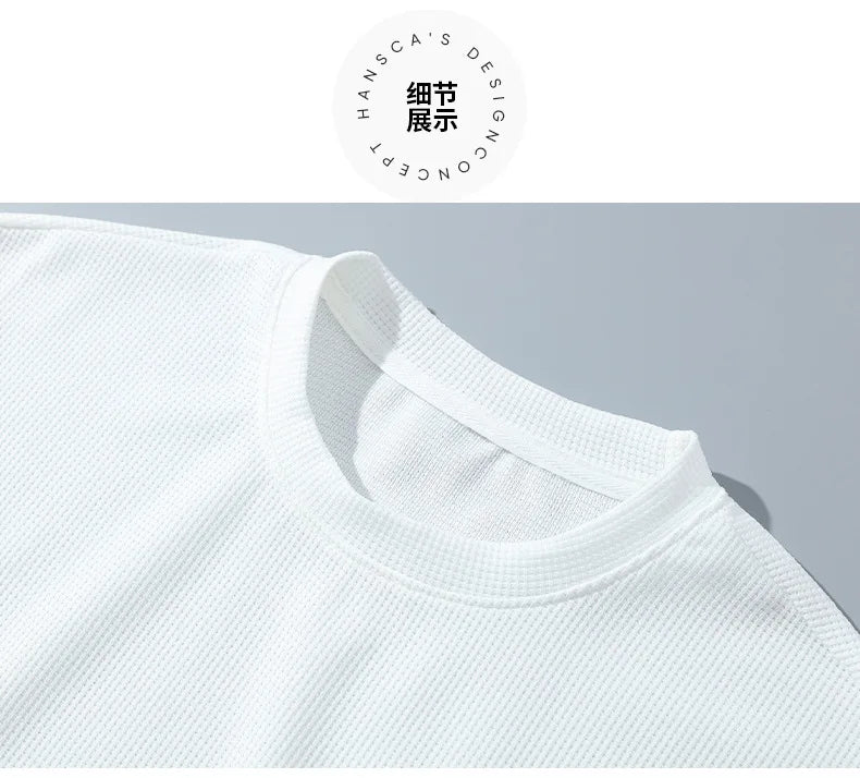 Close-up of a white shirt collar with a brand logo in the corner.