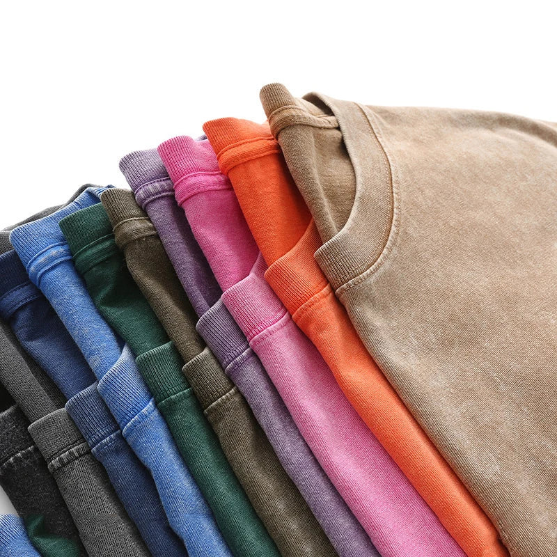 Stack of folded colorful shirts on a white background