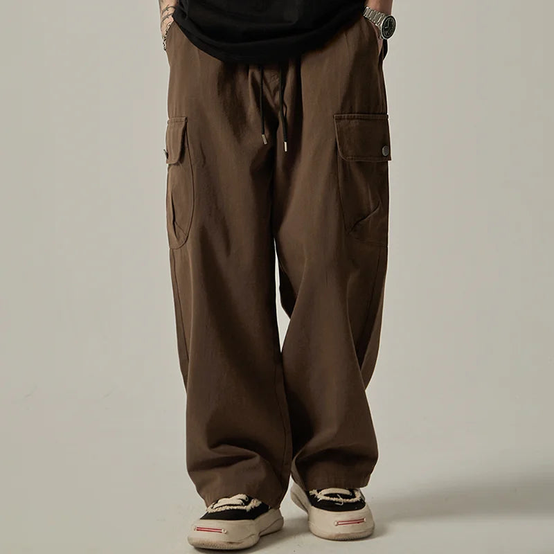 Brown baggy pants worn by a person on a plain background