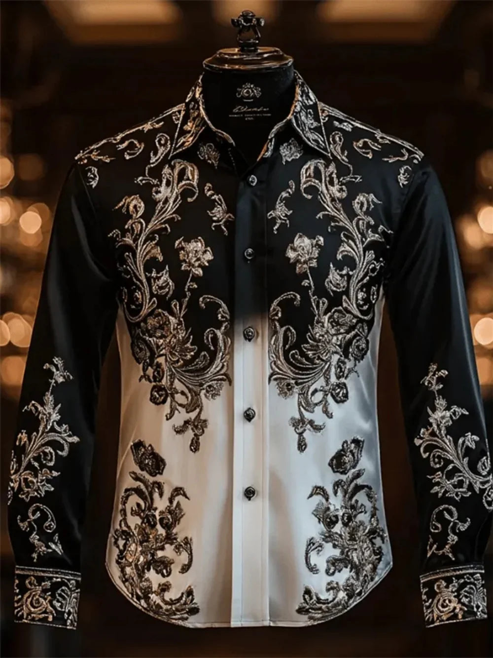 Elegant black and white embroidered shirt on a mannequin against a blurred background