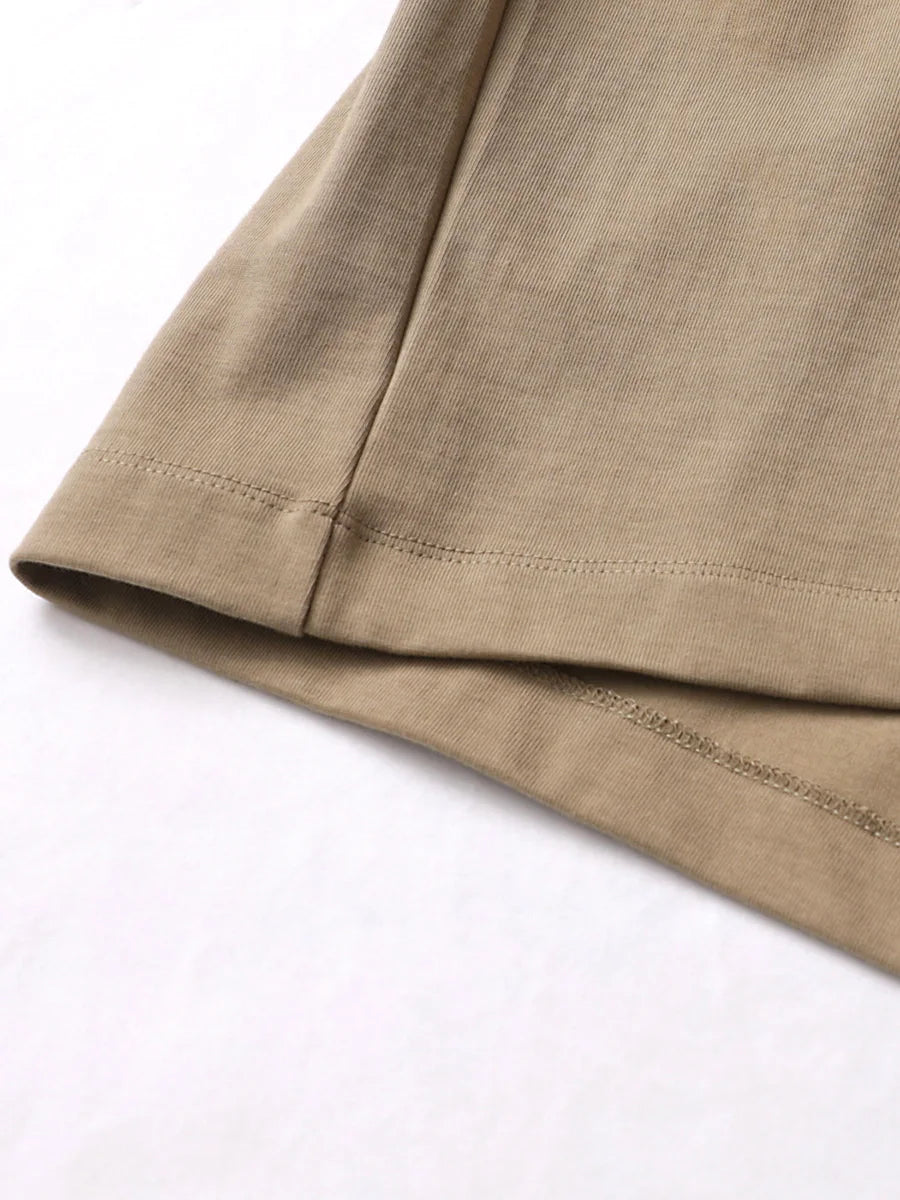 Close-up of a brown fabric with visible stitching on a white background
