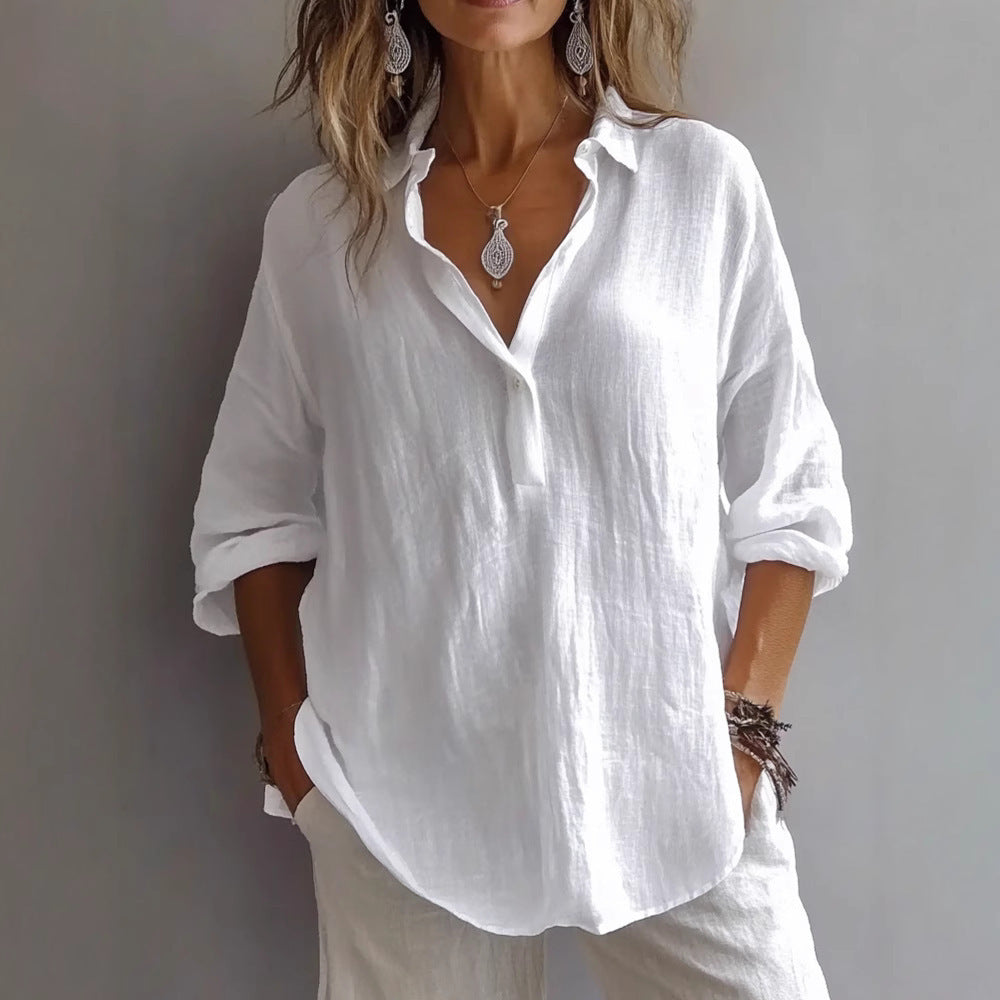 Woman wearing a stylish white long-sleeved lapel pullover shirt with rolled sleeves and jewelry, exuding elegance.